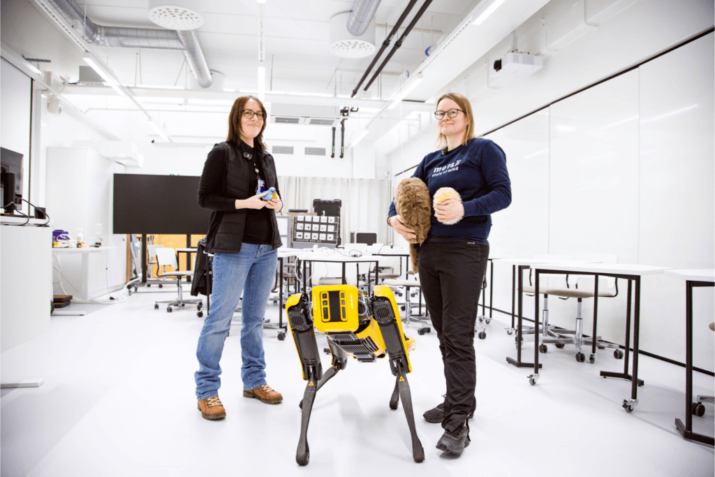 Two women and a robot dog.